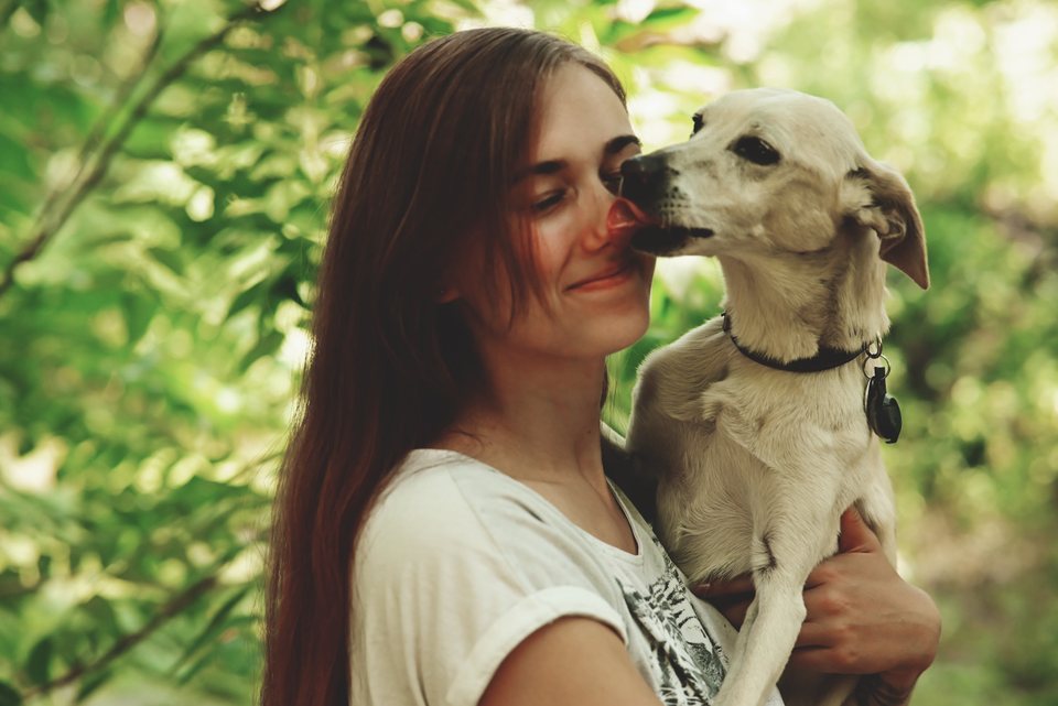 Lou lacht, der Hund gibt ihr einen Kuss