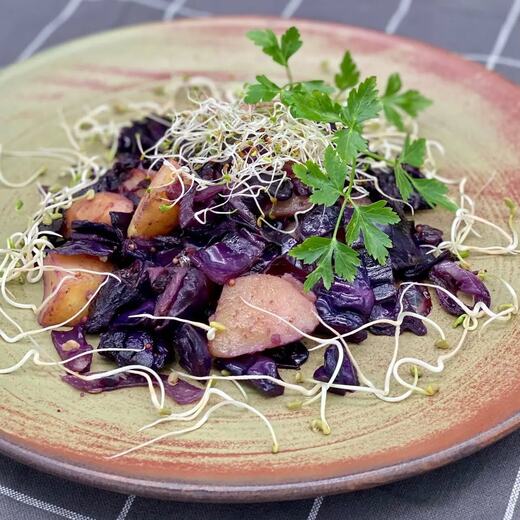 Deftige Rotkohlpfanne mit Kartoffeln, Zwiebeln und frischen Sprossen